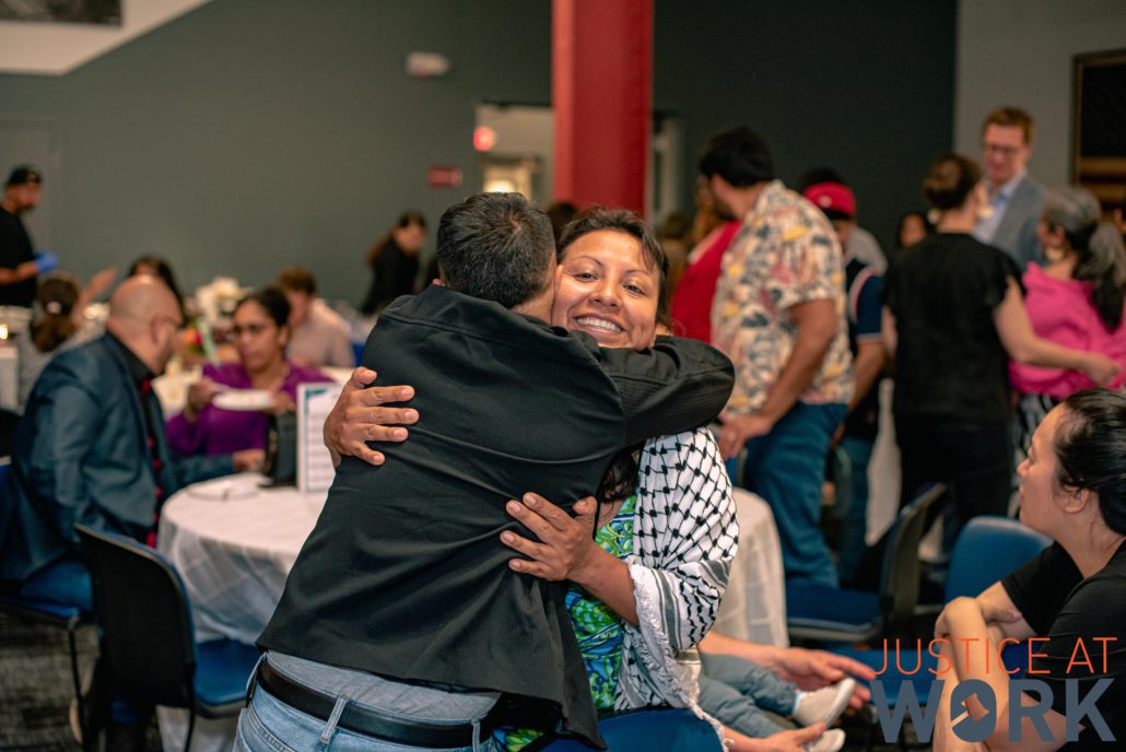 People hugging at a social gathering.