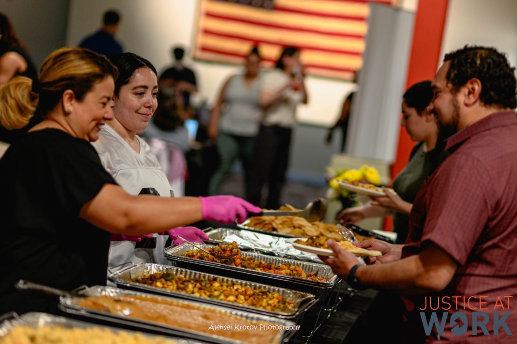 People serving food at a community event.